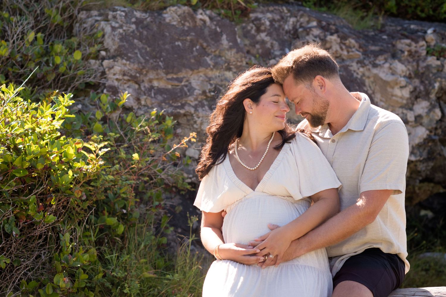 A couple embraces and laughs together during their coastal photo session.