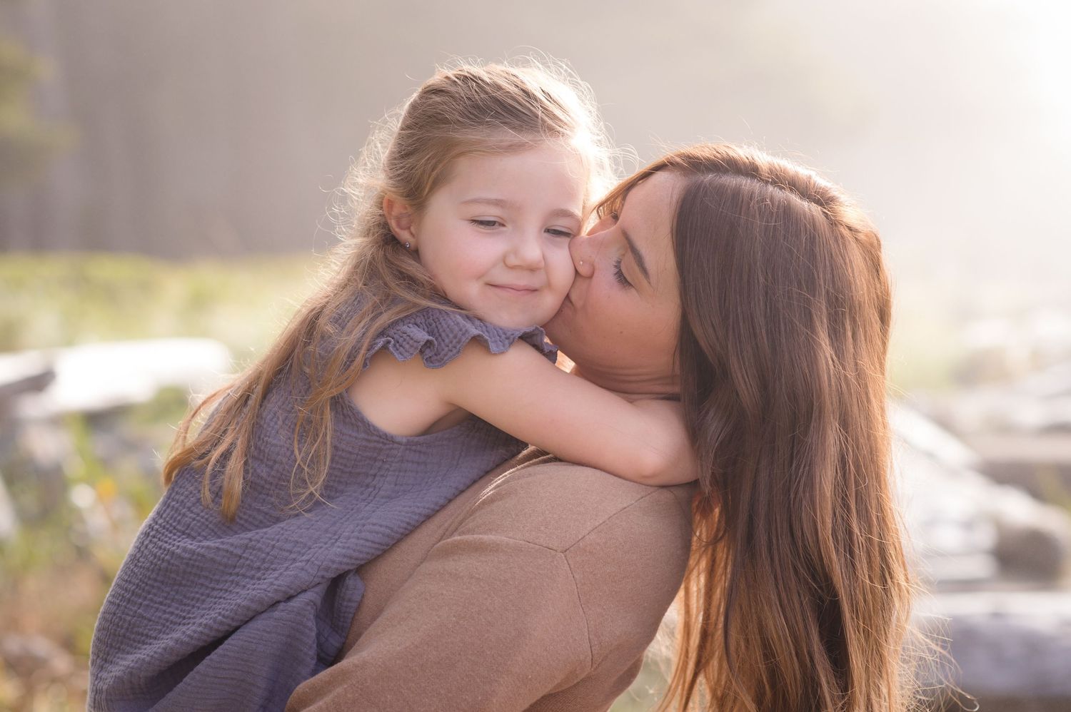 Intimate family portraits taken in warm sunlight at the beach.