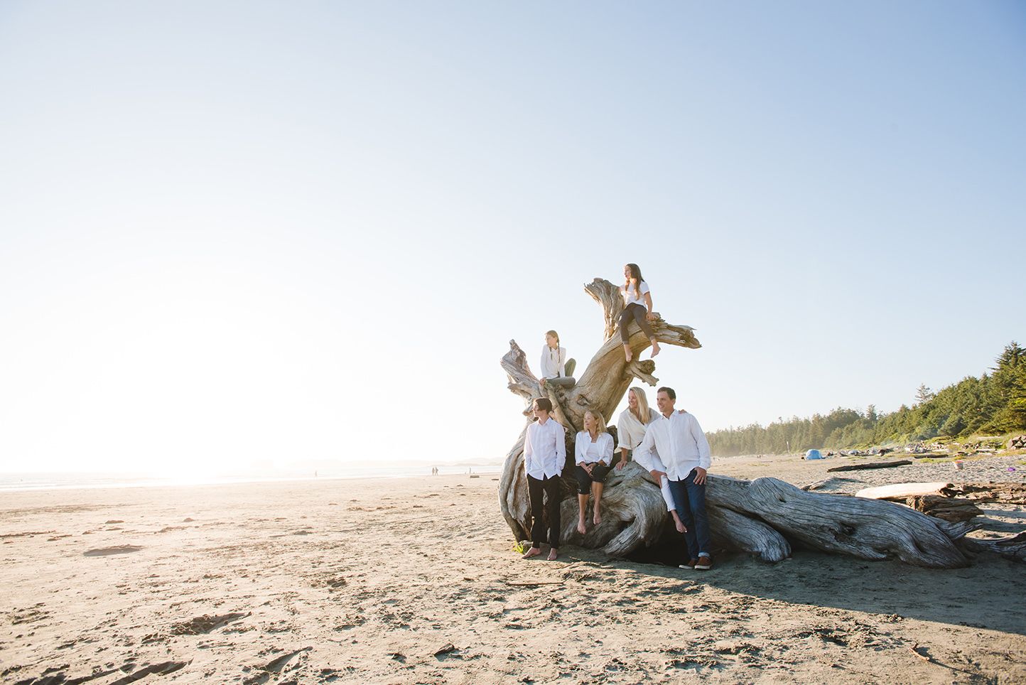 A collection of beach engagement photos showing couples enjoying romantic moments on a sandy shoreline at sunset.