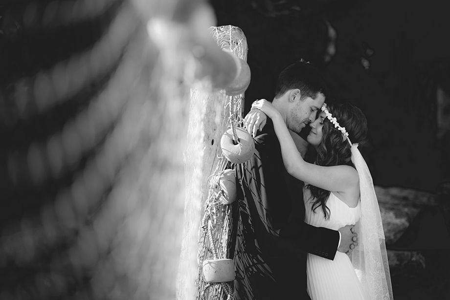 Artistic black and white wedding portraits in dramatic lighting.