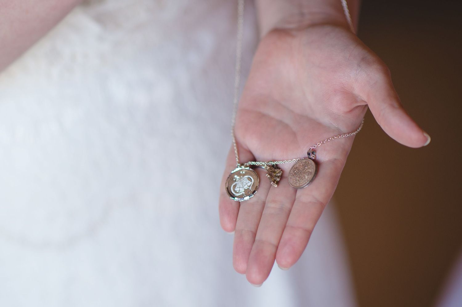 A close-up shot of wedding rings being exchanged between hands.
