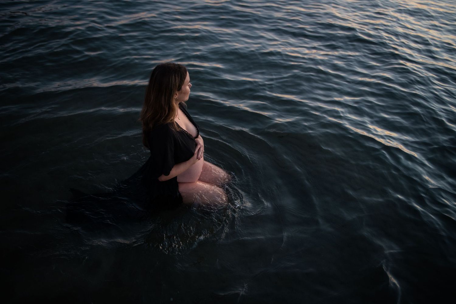 Serene water photography session with dark waves at dusk.