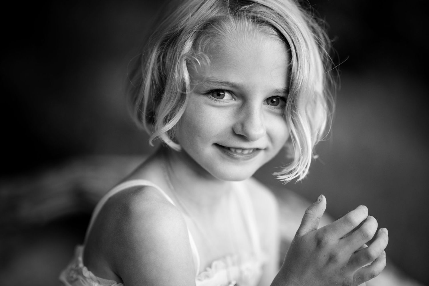 Black and white portrait series showing a child's candid expressions and playful moments.