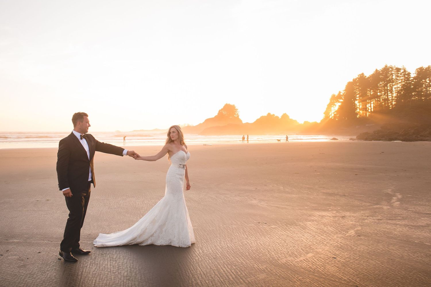 Golden hour wedding portraits on a serene beach at sunset.