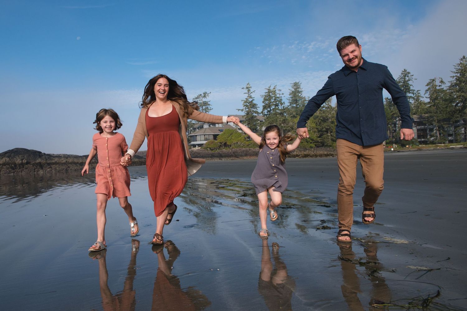 Group playing and splashing in the shallow ocean water.
