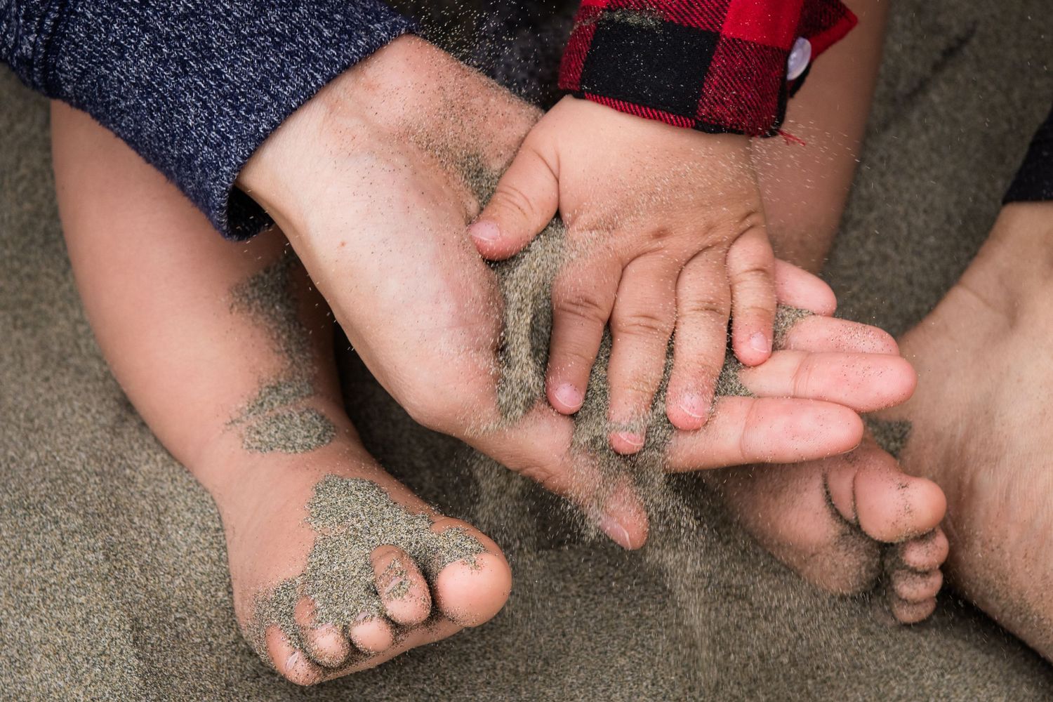 Close up of sandy bare feet on concrete surface.