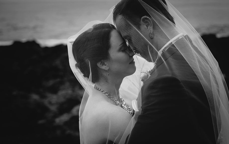 Black and white romantic wedding portraits with couples under umbrellas.