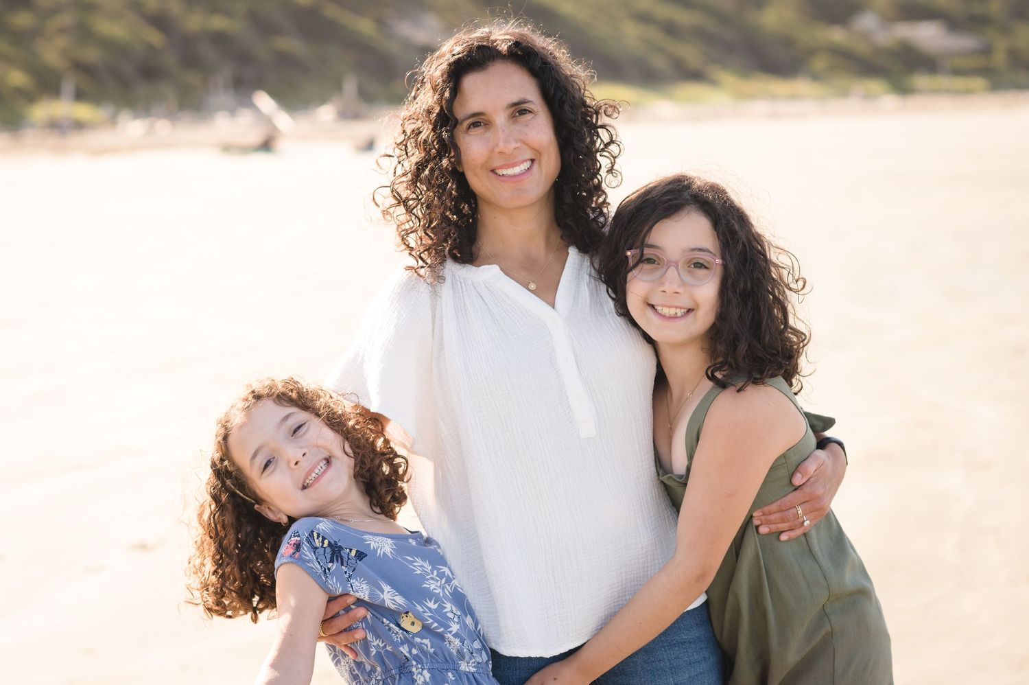 Natural light portraits of family members on sunny beach with soft lighting.