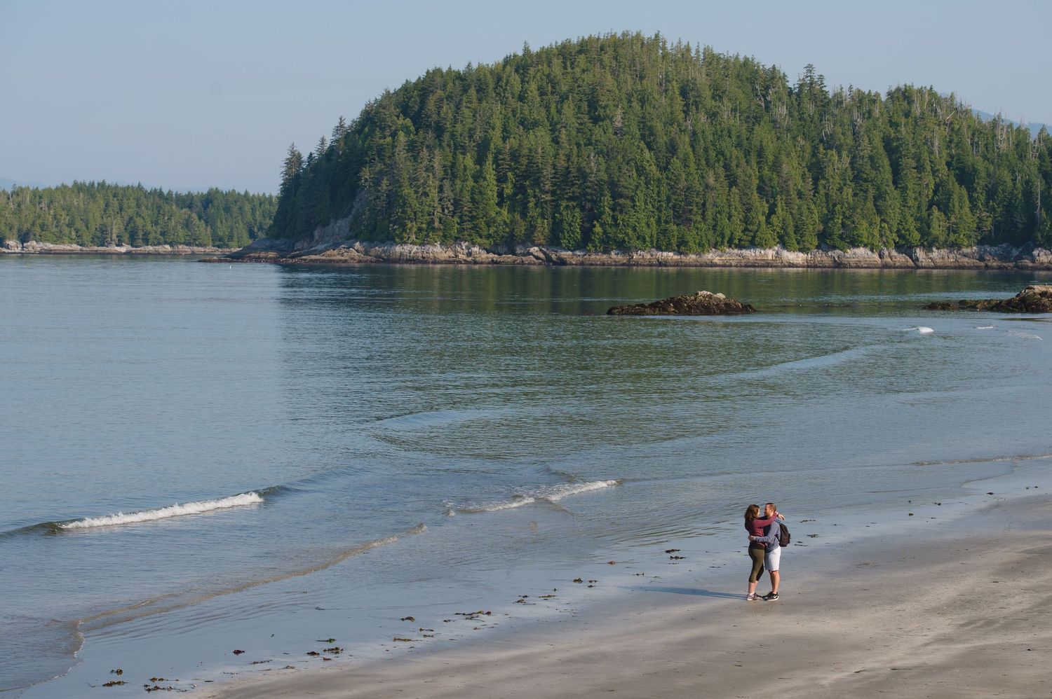 Scenic coastal landscape with forested islands and rocky shoreline along the Pacific Northwest coast during daytime.