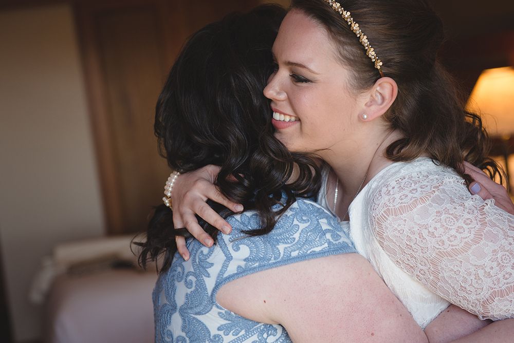Wedding party members share embraces and smiles during celebrations.