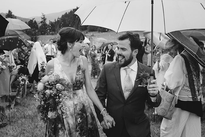Wedding celebration candid moments with umbrellas and bouquets outdoors.