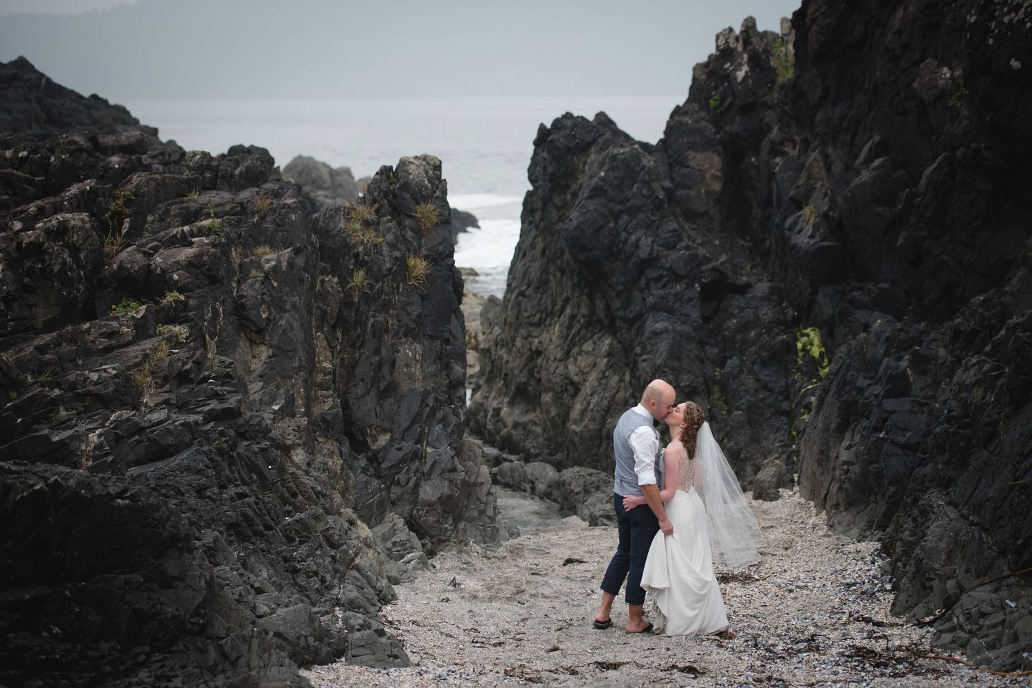 A series of romantic wedding photos captured on a rocky coastal landscape with dramatic cliffs and ocean views.