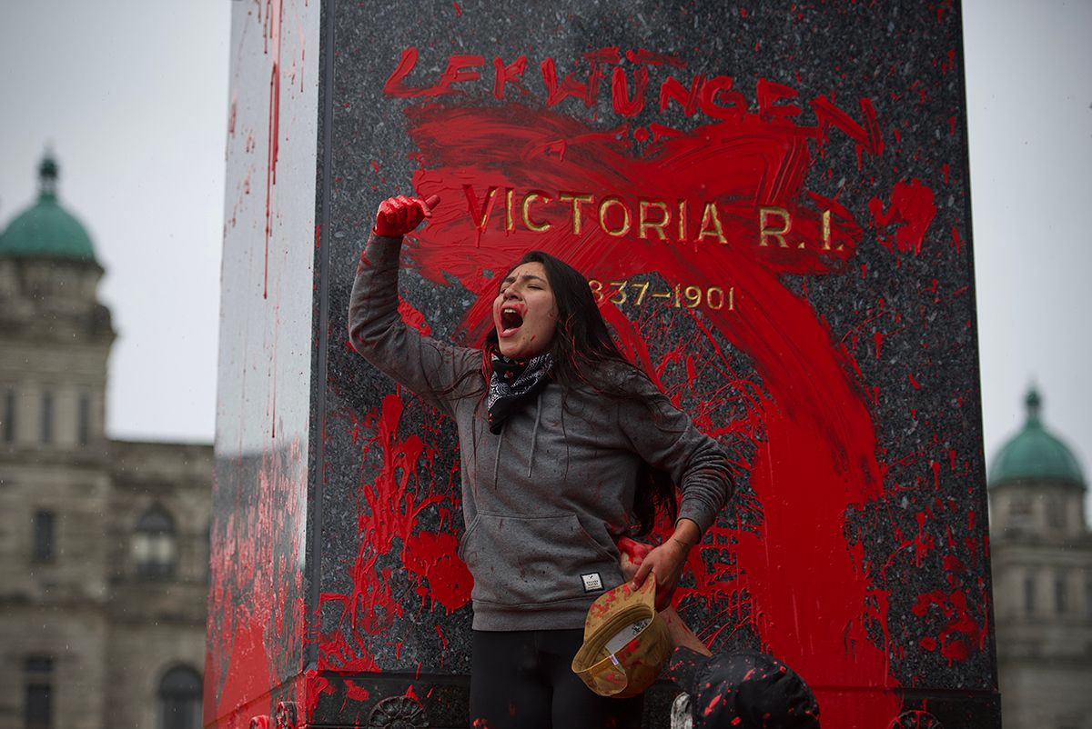 Fairy Creek blockade. Red paint splattered on a wall near a government building with domed architecture.