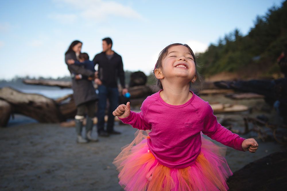 A series of candid outdoor shots showing a person in a pink tutu and top dancing joyfully at sunset.