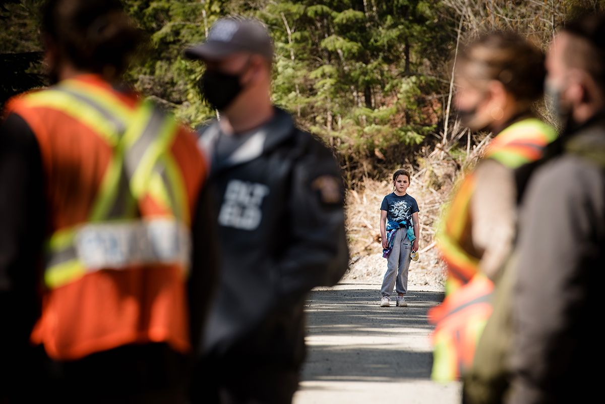 Fairy Creek blockade. People in safety vests gathering on a paved road during a demonstration.
