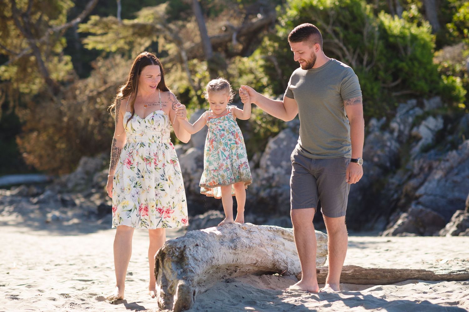 Family spending quality time together on scenic beach with rocky cliffs.