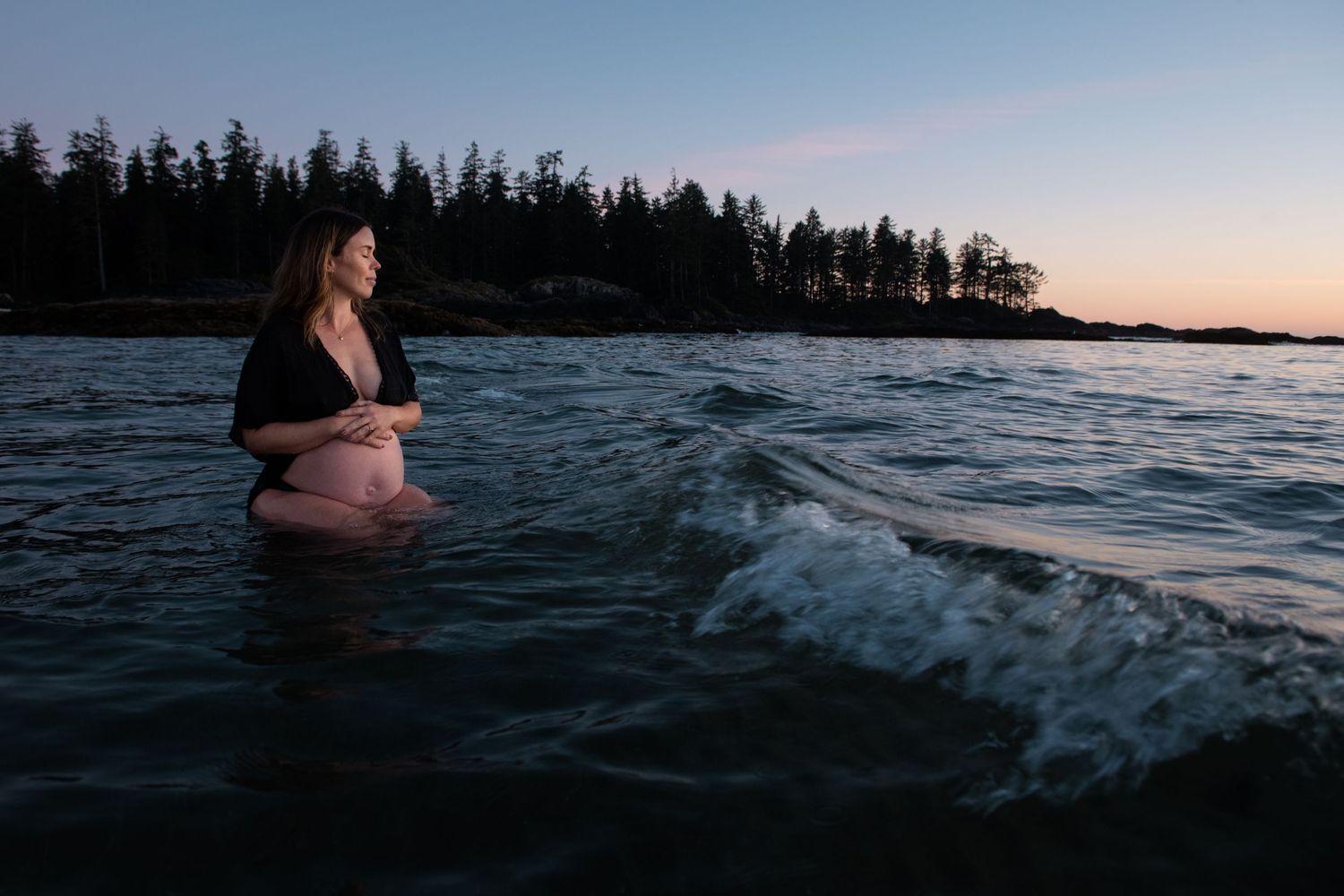 Coastal photography with waves crashing against rocky shore during sunset.