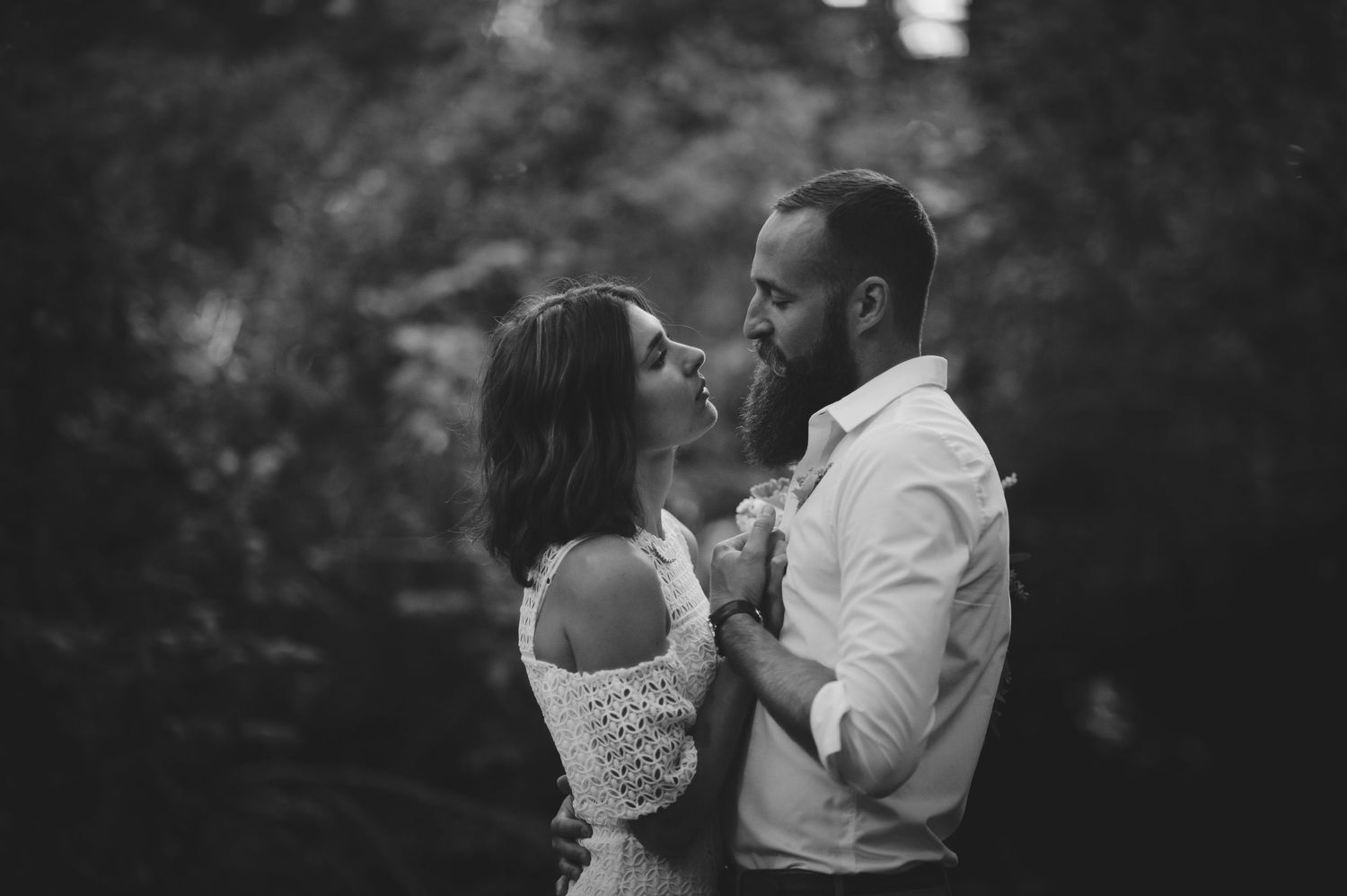 A romantic black and white photo series showing couples embracing in an outdoor setting.
