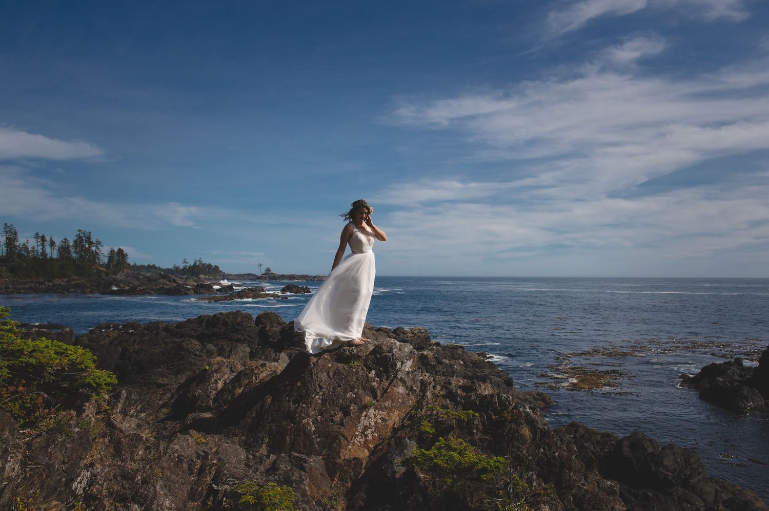 Scenic wedding portraits captured on dramatic coastal cliffs overlooking the ocean.