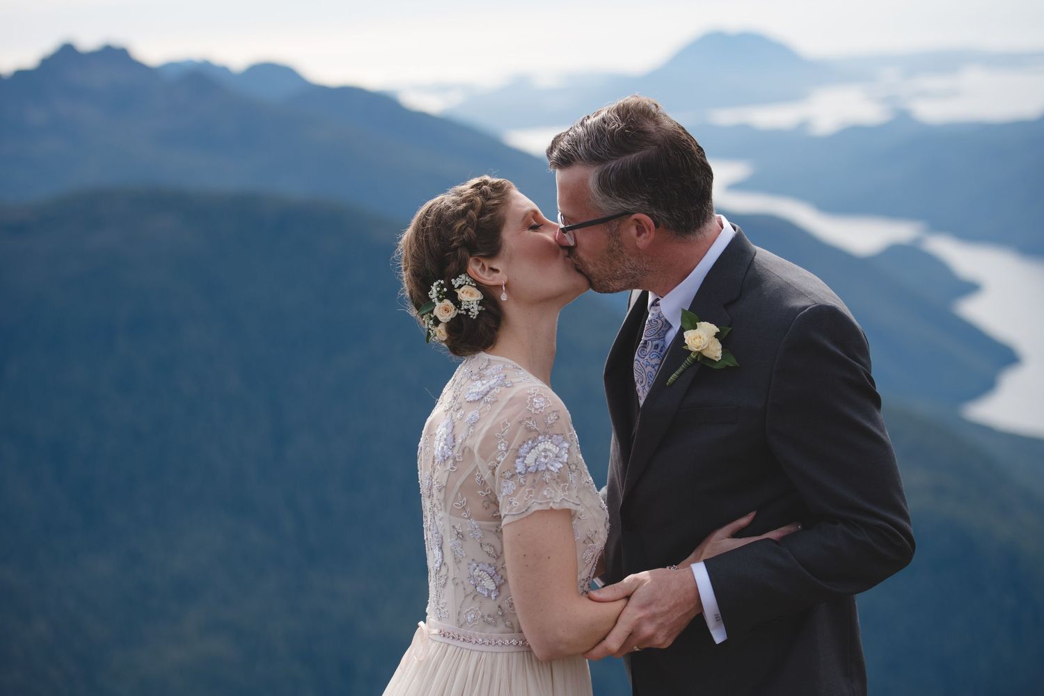 A couple shares emotional moments during their mountain peak wedding ceremony.