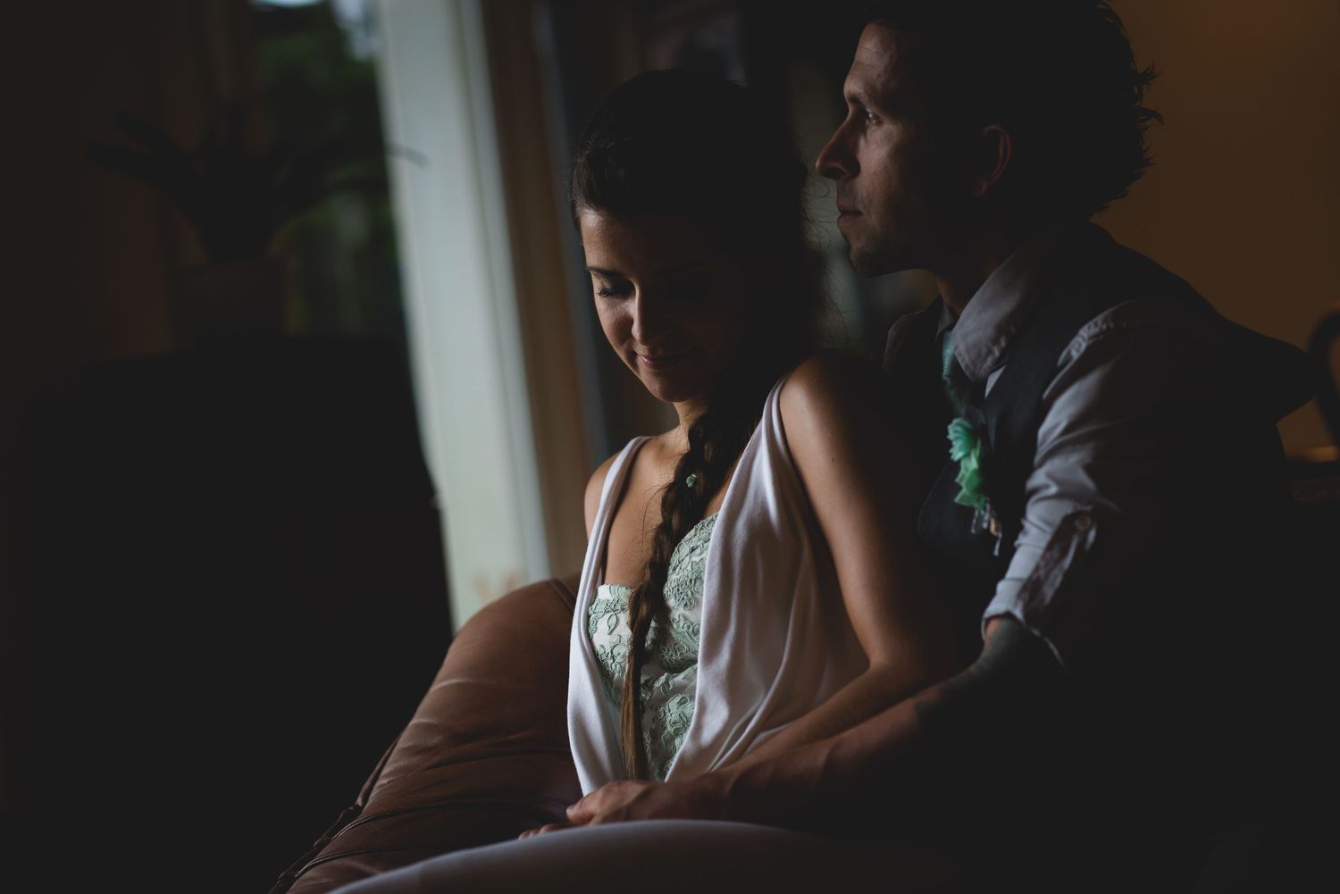 Dimly lit interior space with silhouettes and ambient lighting.