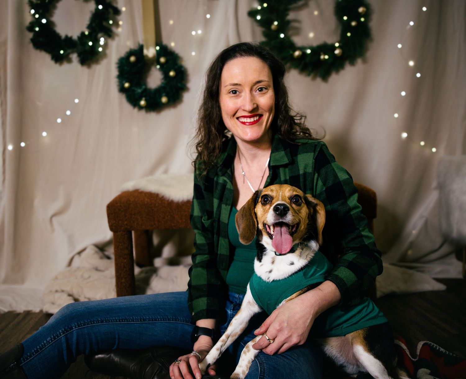 Holiday family photos with Christmas wreaths and twinkle lights in background.