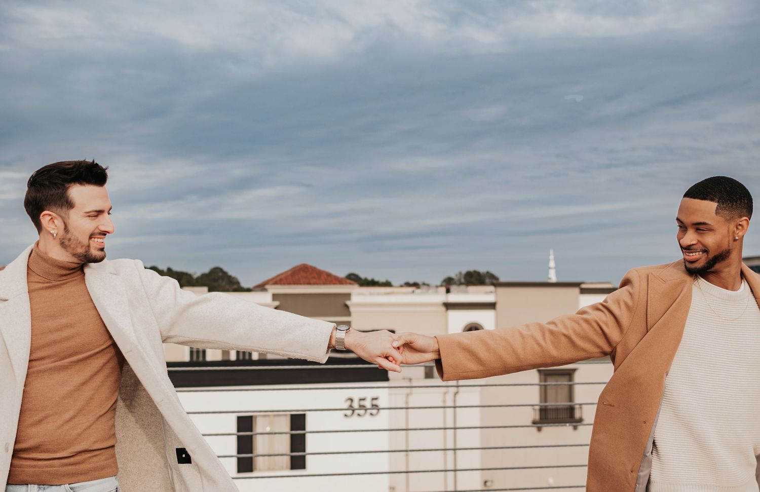 Romantic rooftop LGTBQ engagement photography with Huntsville skyline views