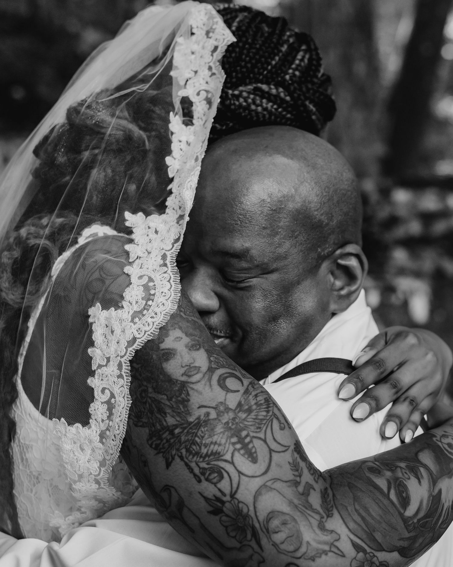 Father hugging bride in close-up black-and-white wedding image, proud and emotional moment, photographed by Catch Your Fire Photography.