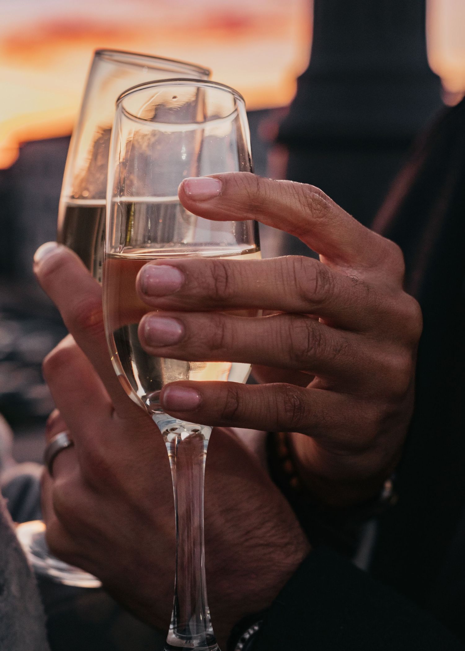 Intimate champagne toast at sunset closing out LGBTQ+ rooftop engagement session