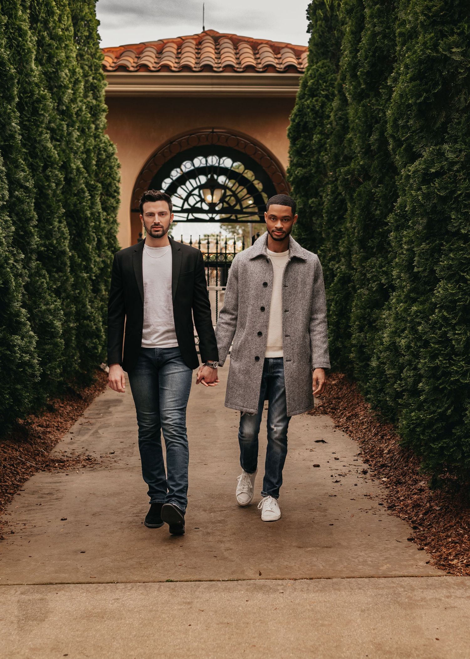 LGBTQ+ couple walking hand in hand through Westin courtyard at Bridgestreet in Huntsville Alabama