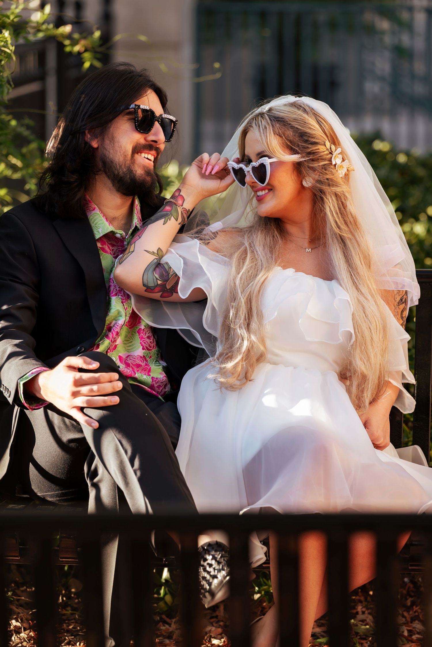 Fun candid moment of bride and groom resting on bench on sunny day, photographed by Catch Your Fire Photography in Huntsville, AL.