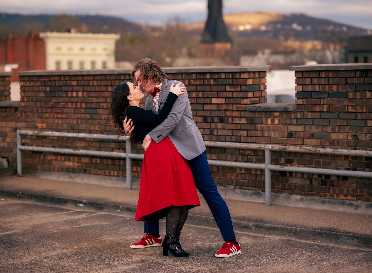 Engaged couple dancing together on a downtown rooftop, photographed by Huntsville photographers Carolyn Patterson and her husband.