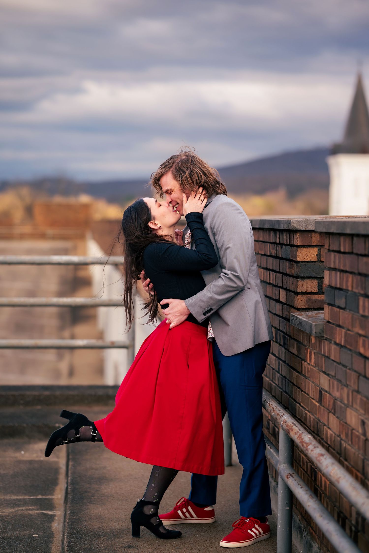 Romantic kiss atop the parking garage rooftop in downtown Huntsville engagement session captured by Carolyn Patterson of Catch Your Fire