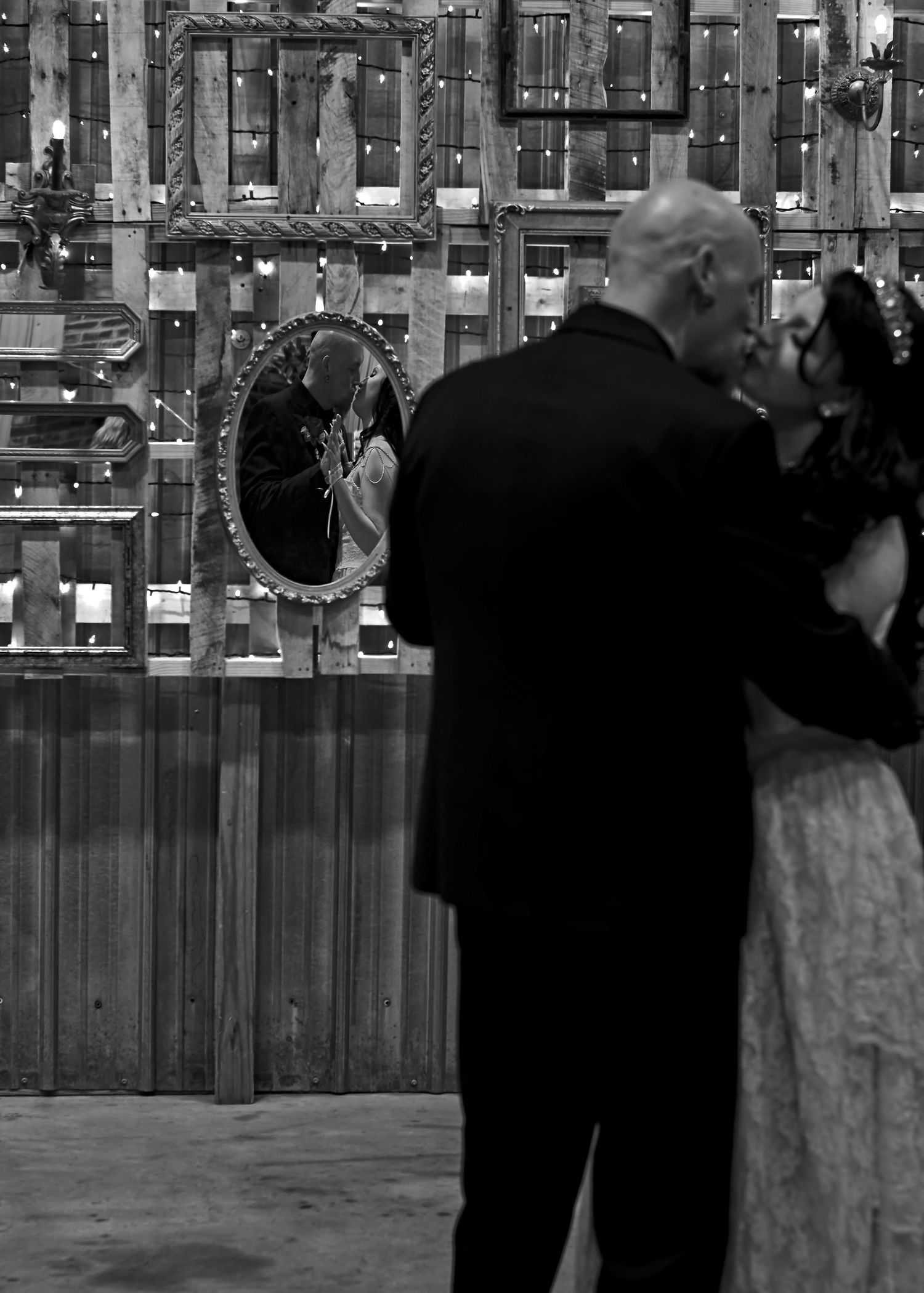 Black and white image of couple’s first dance reflected in mirrors, captured by Catch Your Fire Photography.