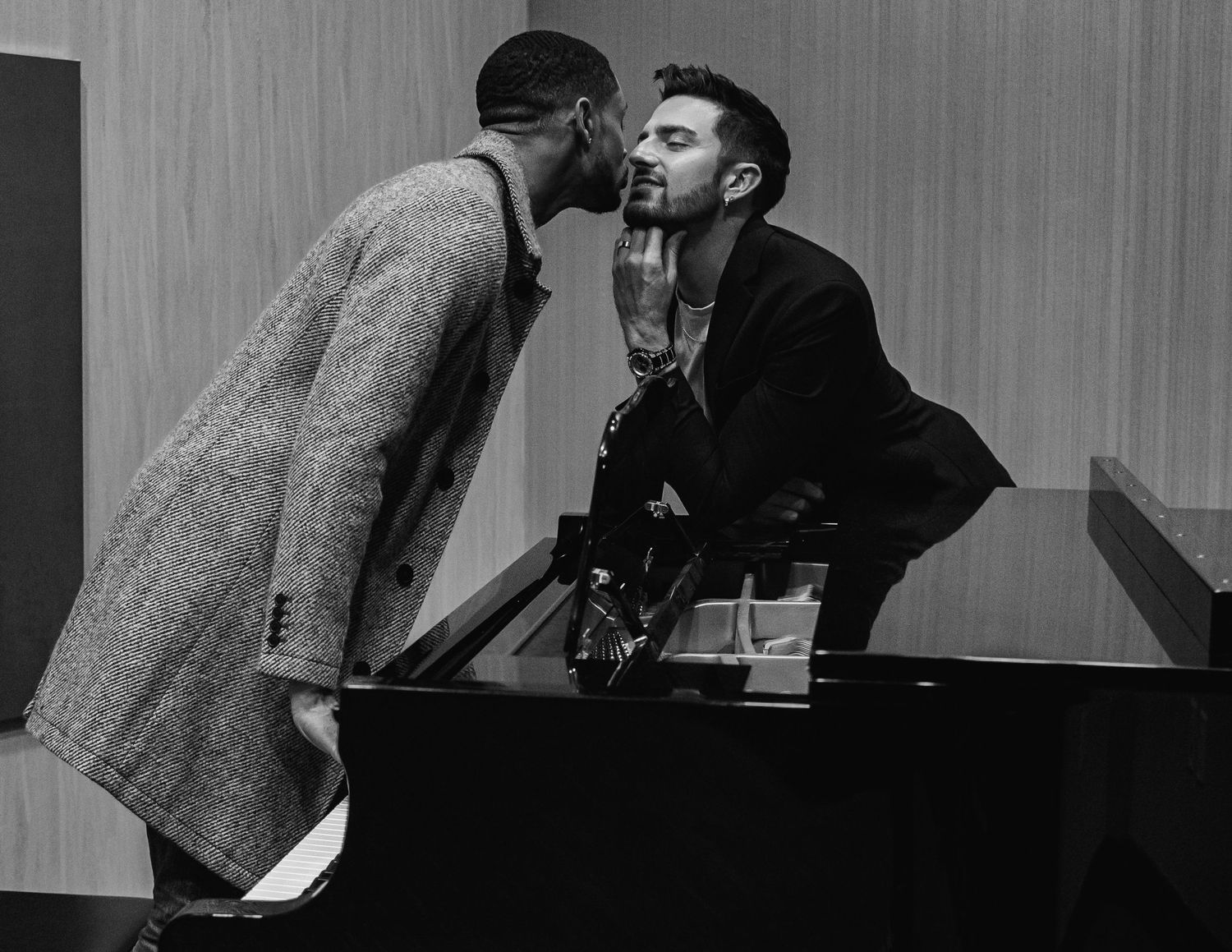 black and white candid photo of LGBTQ+ engagement session featuring intimate piano moments at The Westin Huntsville