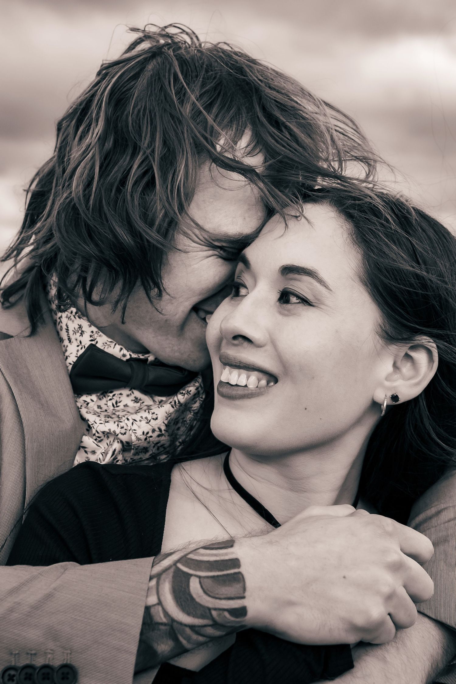 Intimate downtown Huntsville engagement close-up of couple sharing a tender moment, photographed by Catch Your Fire Photography