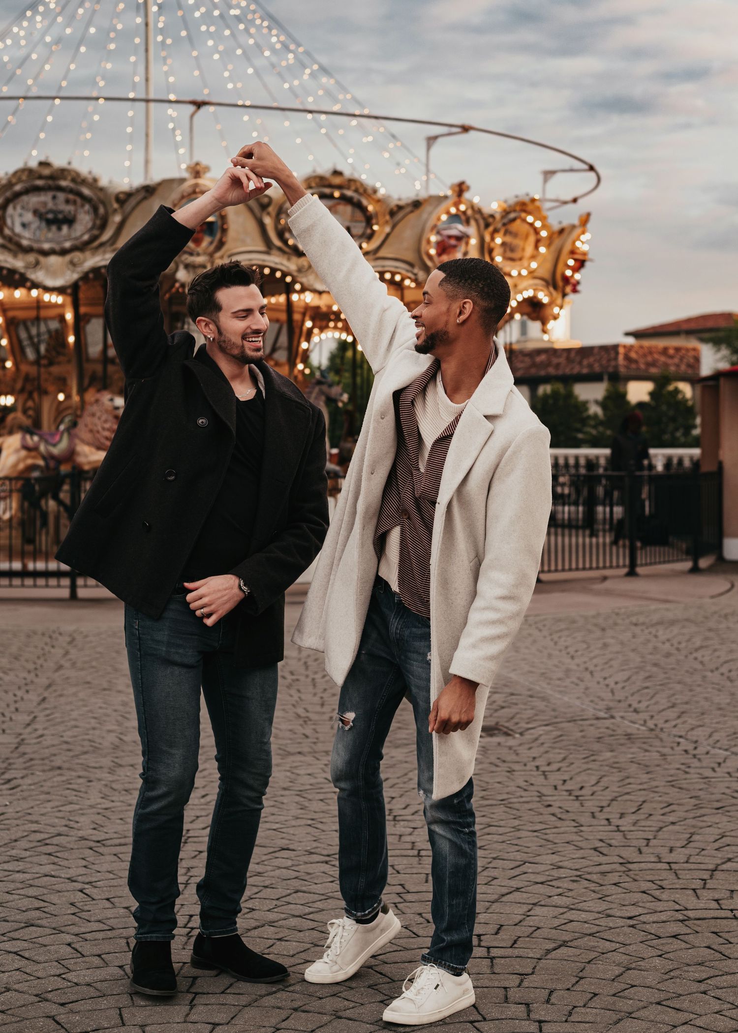 Two grooms dancing after proposal at Bridge Street Town Centre carousel