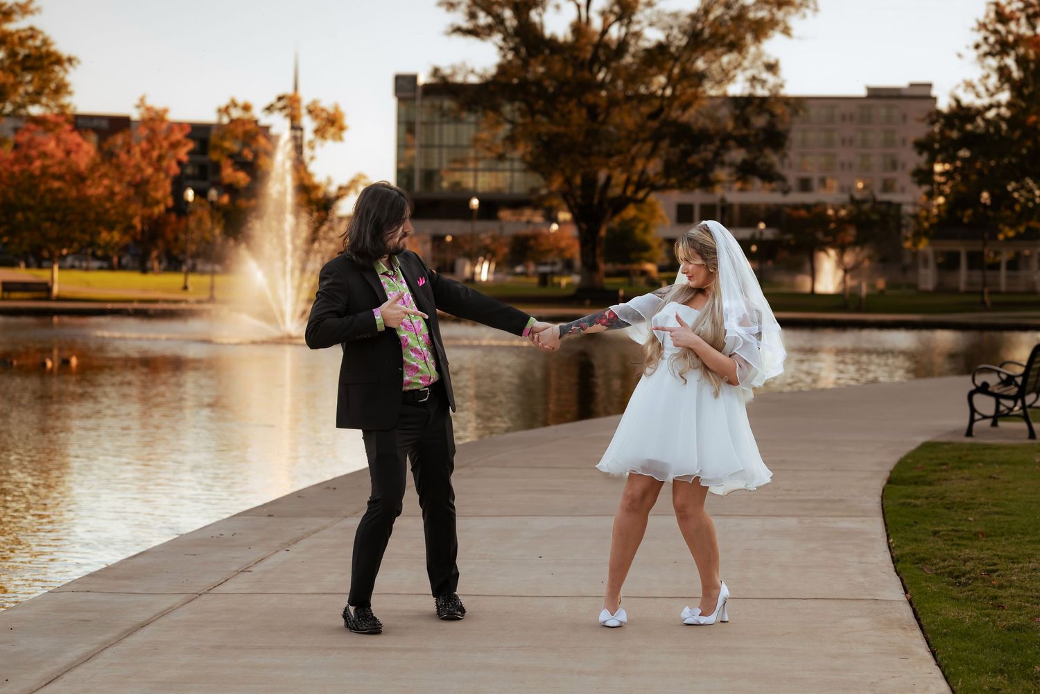Candid shot of bride and groom being silly at Big Spring Park in Huntsville, Alabama by the fountain.