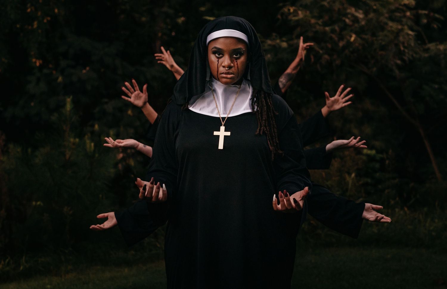 editorial horror image of black woman as a nun bleeding from her eyes with her hands raise to conjure with four sets of hands behind her