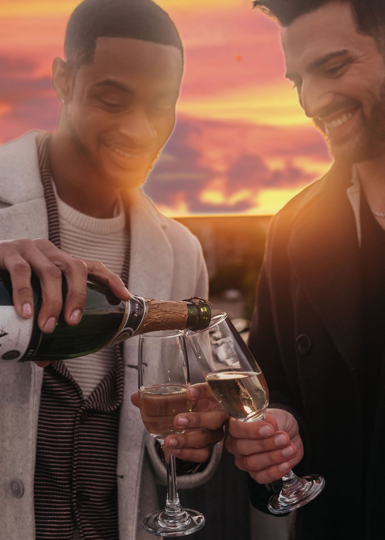 Romantic champagne toast on parking garage rooftop overlooking Bridge Street at sunset