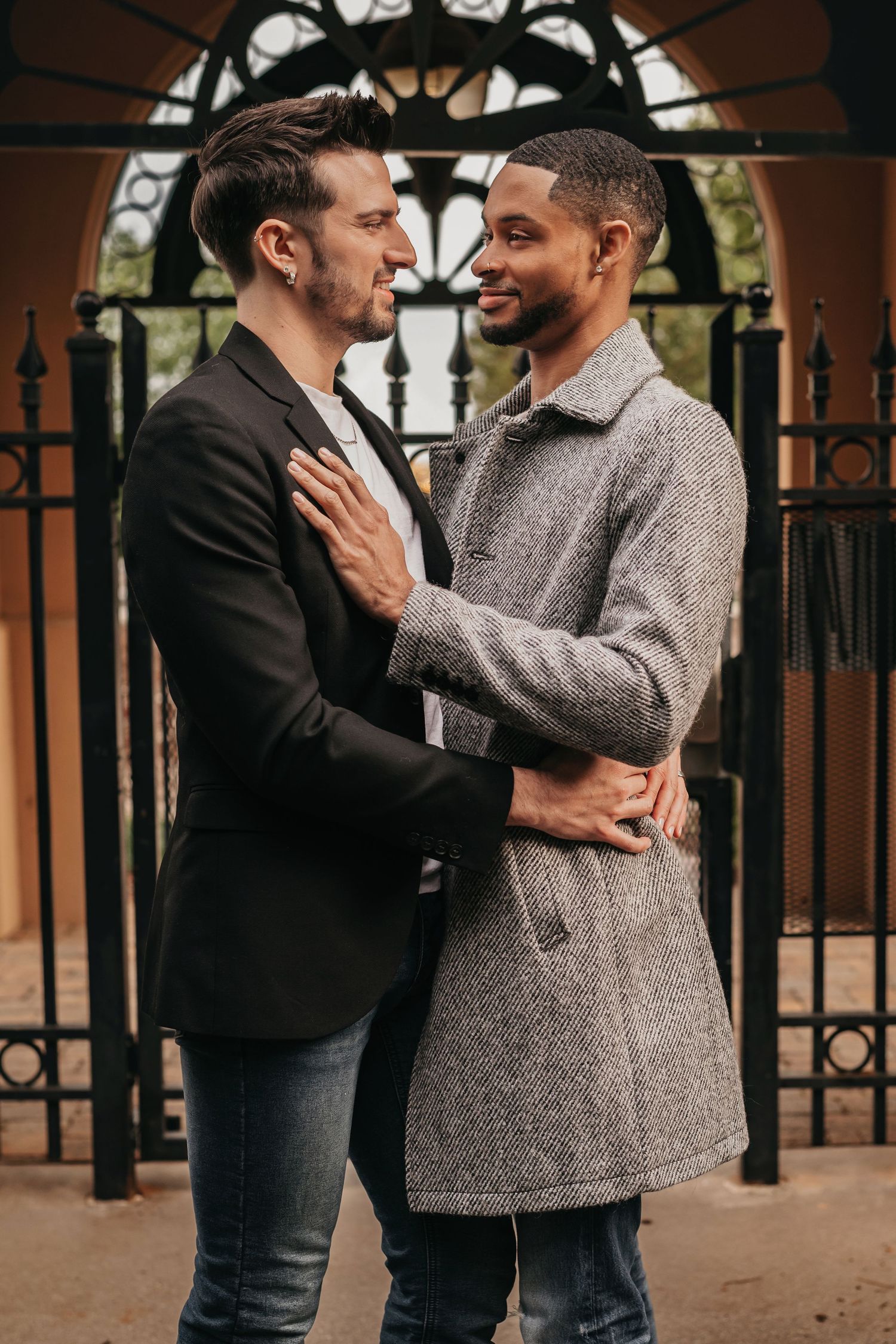 LGBTQ+ couple embracing and laughing in the Westin courtyard at Bridgestreet in Huntsville Alabama