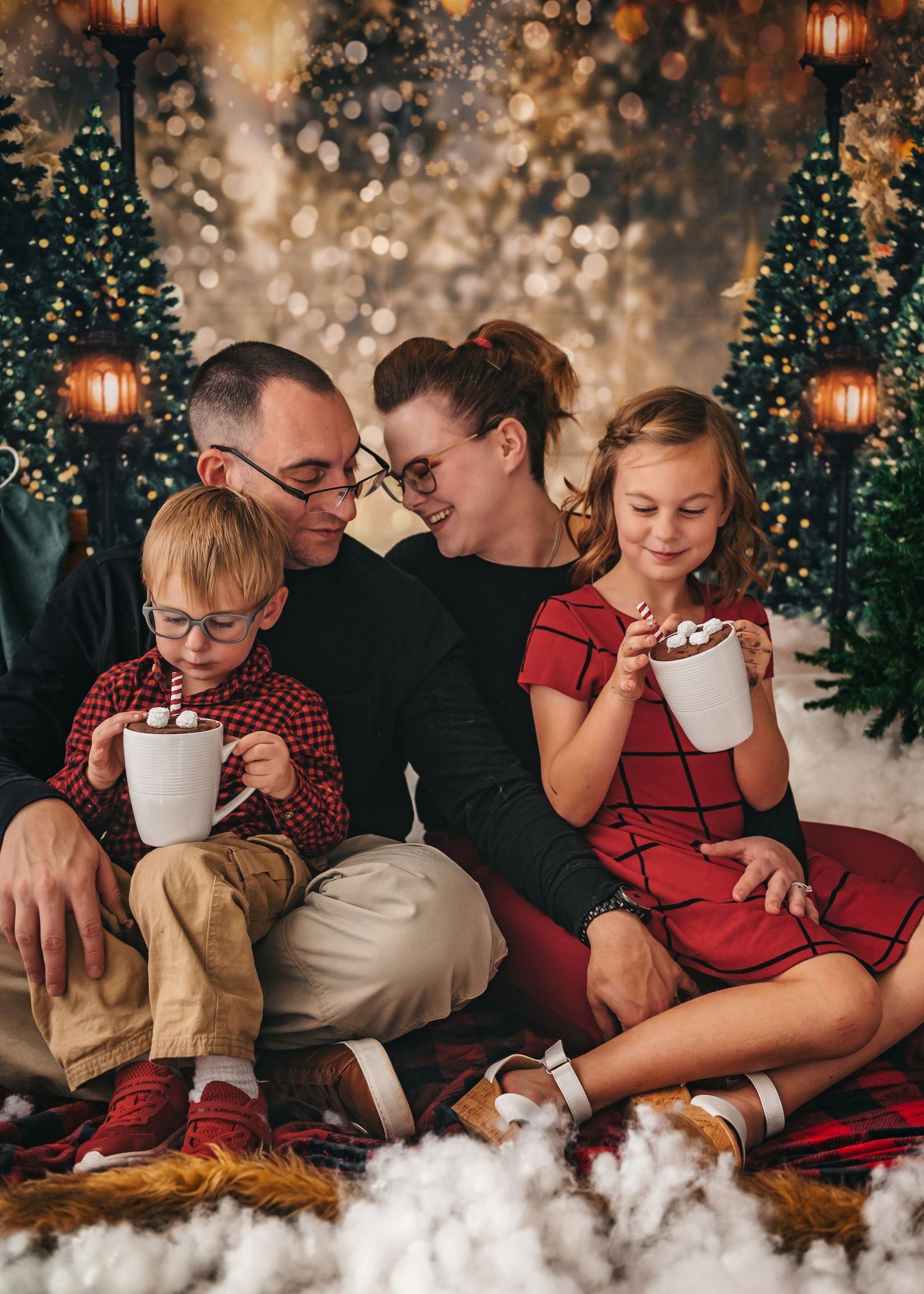 Candid  family moment during Christmas studio session captured by Catch Your Fire Photography in Huntsville, Alabama.