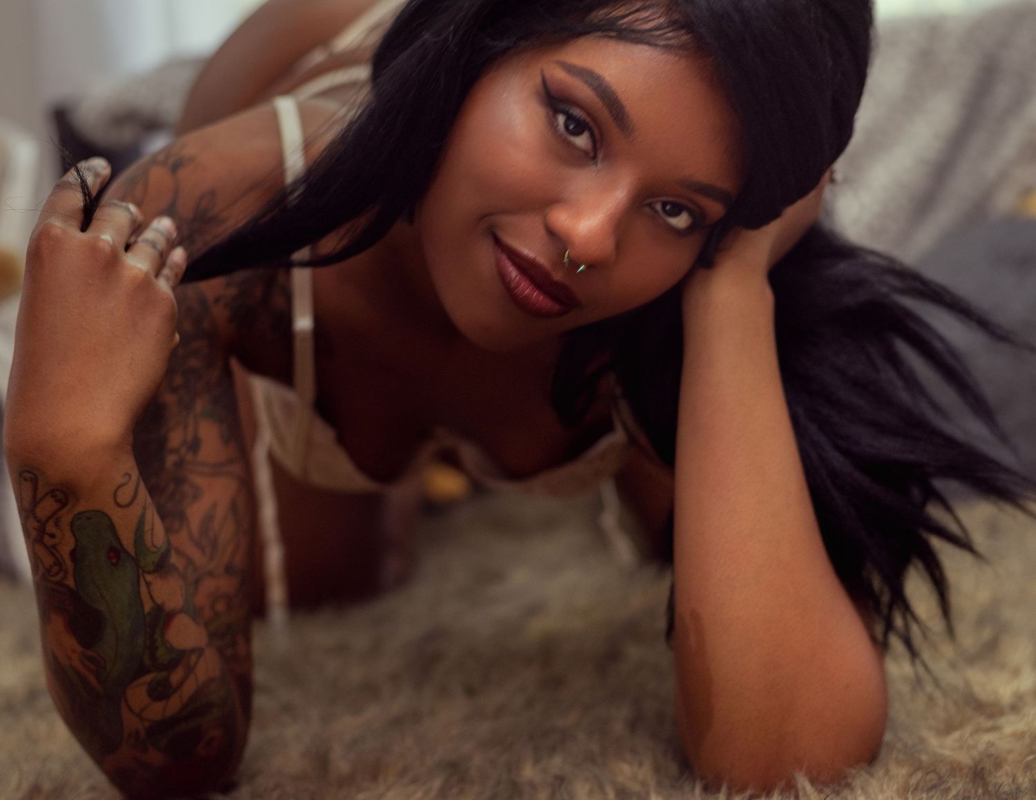 close up of black girl crawling to camera and playing with her hair in studio at Catch Your Fire Photography in Huntsville, AL