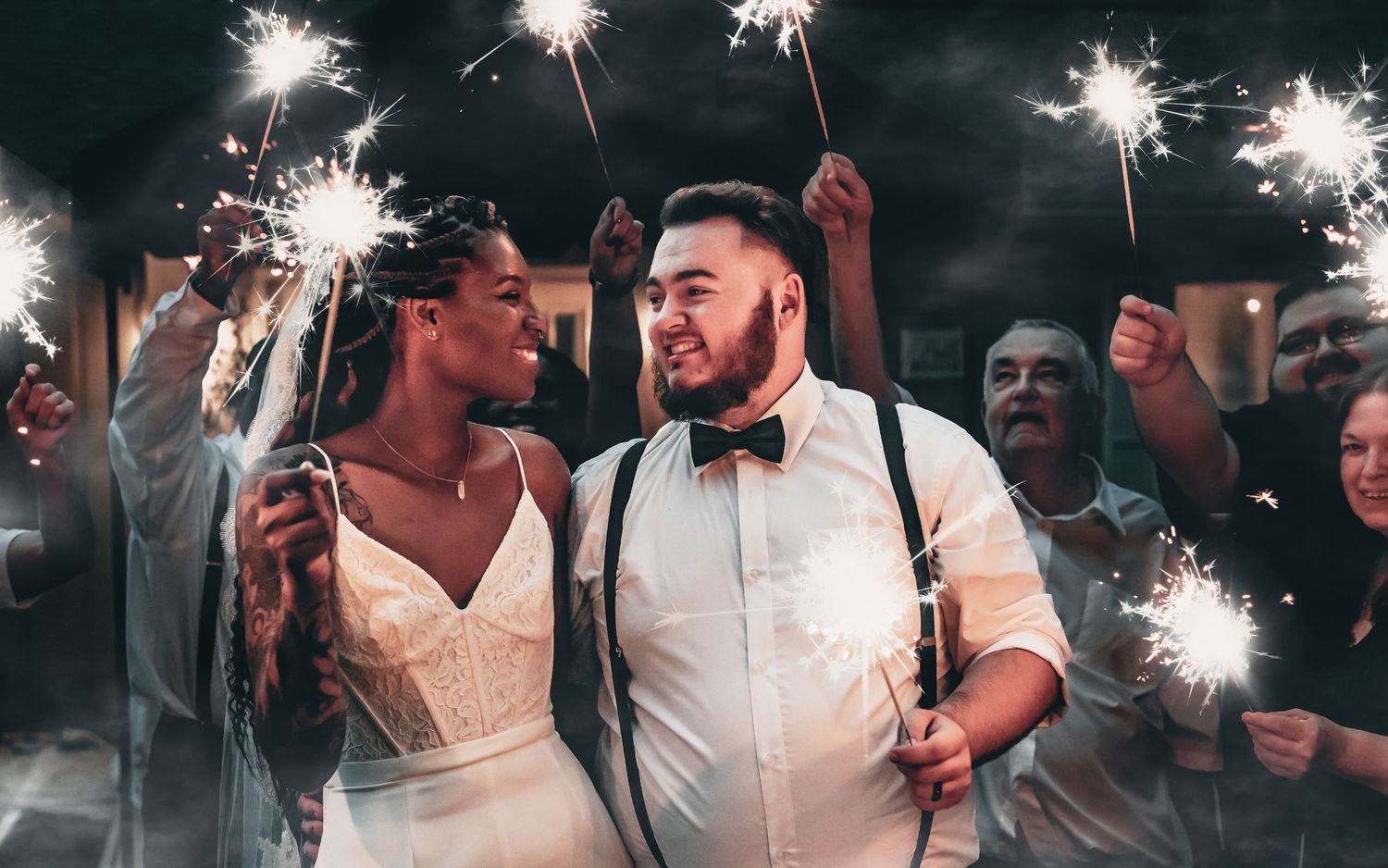 Bride and groom doing sparkler exit at The Wedding Chapel on the Mountain at night photographed by Catch Your Fire Photography