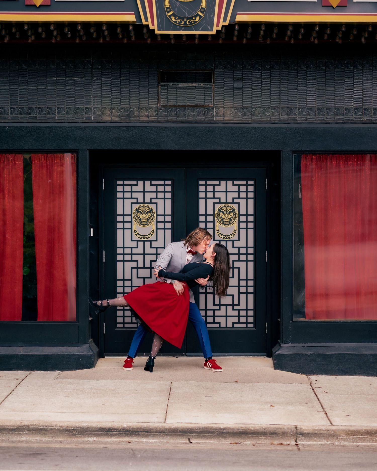 Romantic downtown sidewalk dip and kiss, engagement session by Catch Your Fire Photography in Huntsville, AL