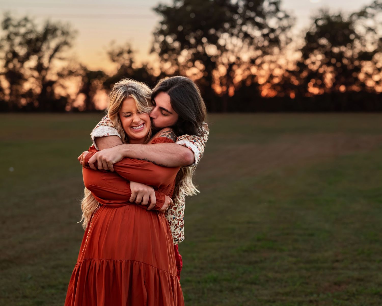 Couple embracing and celebrating after a twirl because she said yes to his marriage proposal at sunset at Tate Farms in Meridianville, AL.