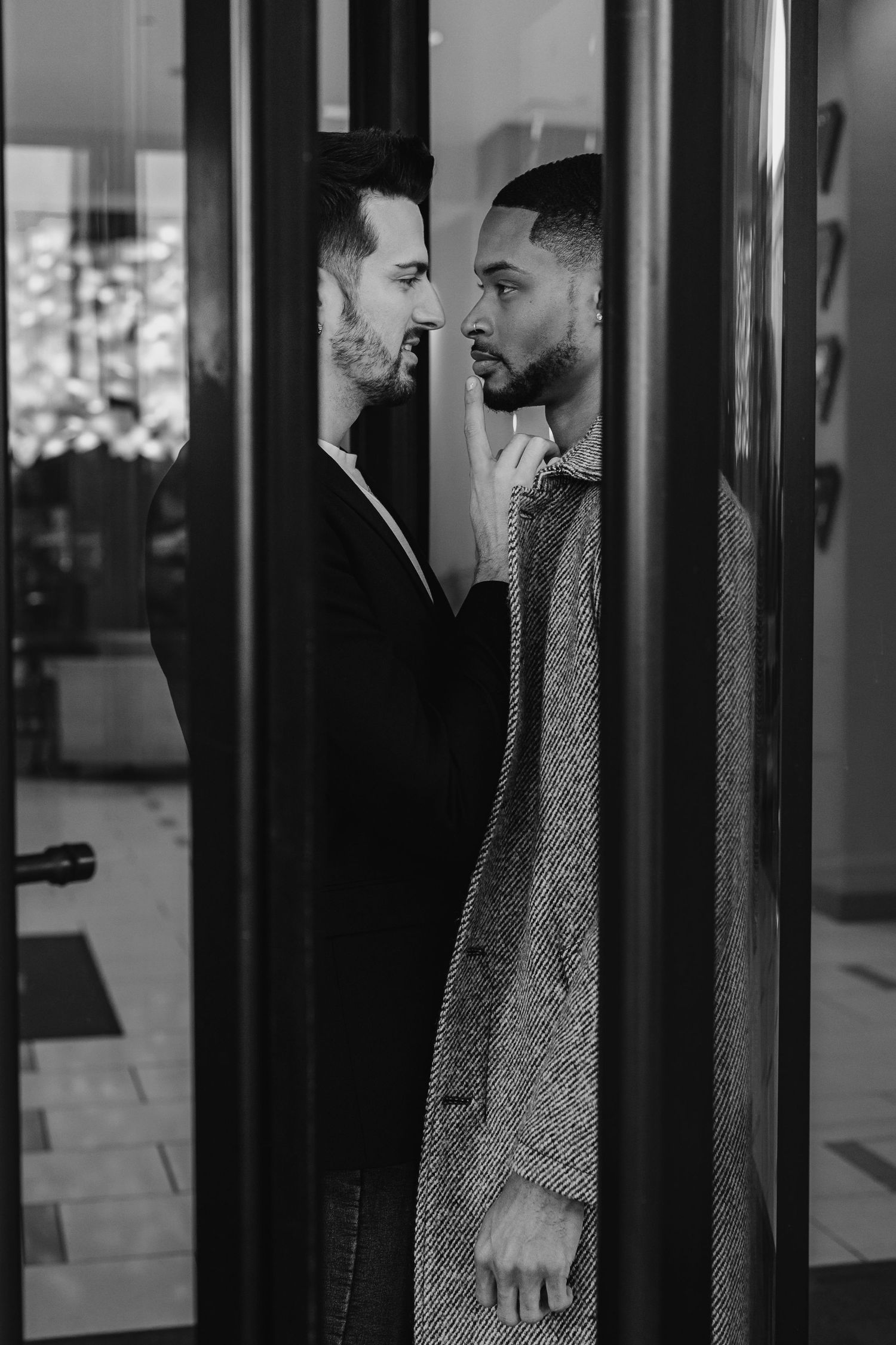 Cinematic engagement portraits in rotating doors at The Westin Huntsville hotel