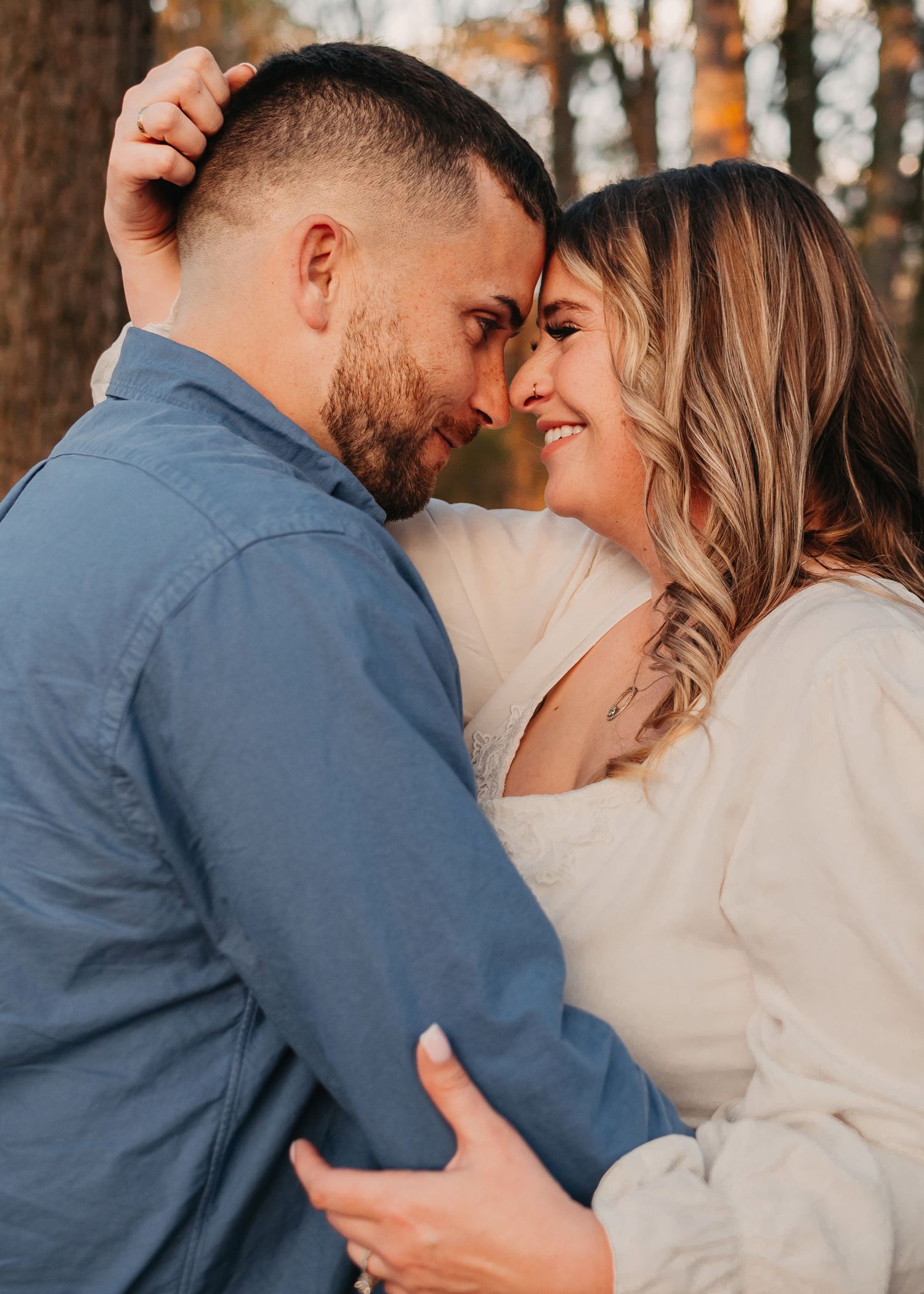 close up engagement portrait of intimate moment with couple touching foreheads and smiling at Lady Ann Lake in Huntsville, AL