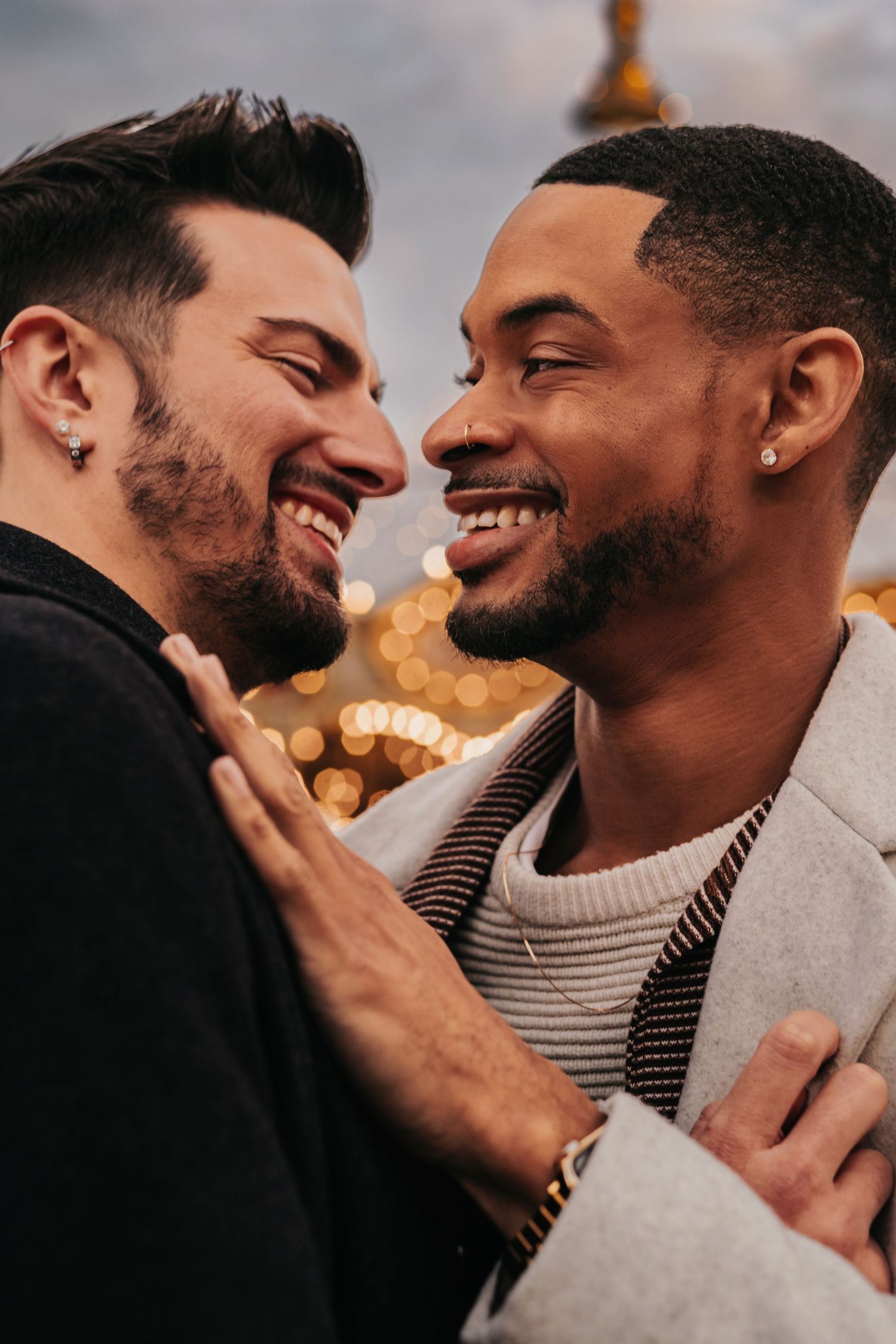 Emotional same-sex proposal close-up moment beside the carousel at Bridge Street Huntsville