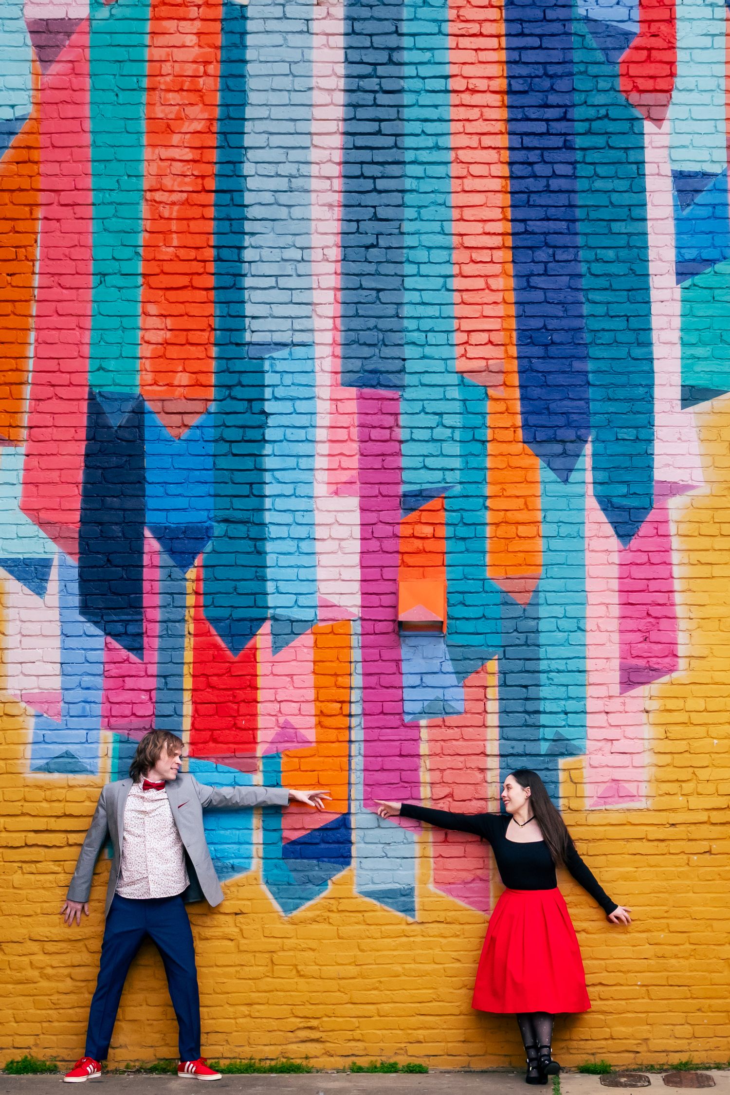 Urban, editorial Huntsville engagement portrait with colorful mural backdrop, photographed by Catch Your Fire Photography